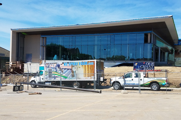 KC Spray Foam and Coatings, LLC trucks outside of commercial building