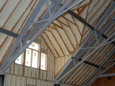 attic ceiling with spray foam insulation applied