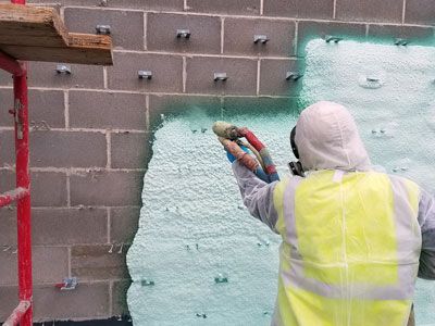 insulation contractor spraying foam with various spray types